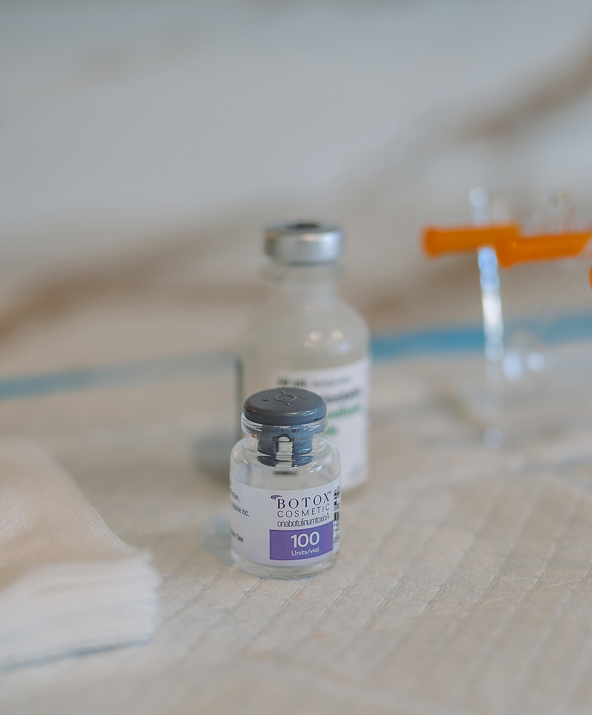 Botox vials on a clinic table surface.