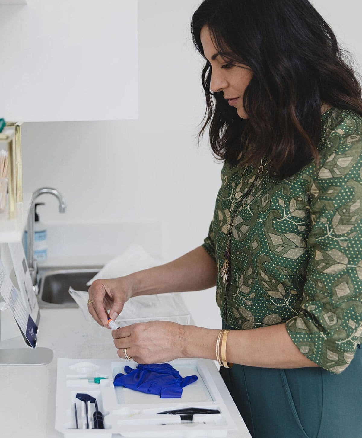 Woman preparing supplies in a clinical setting.
