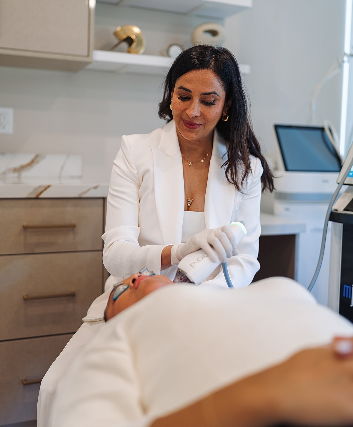 Aesthetician performing treatment on a client.