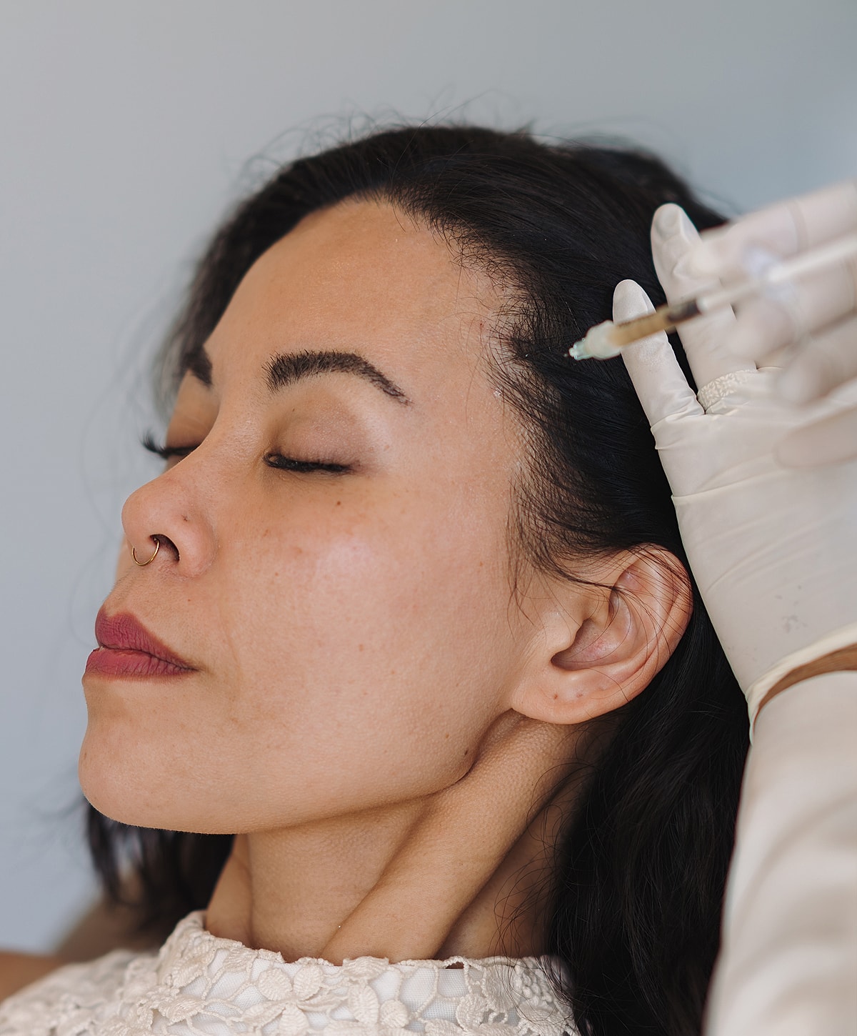 Woman receiving an injection for cosmetic treatment.