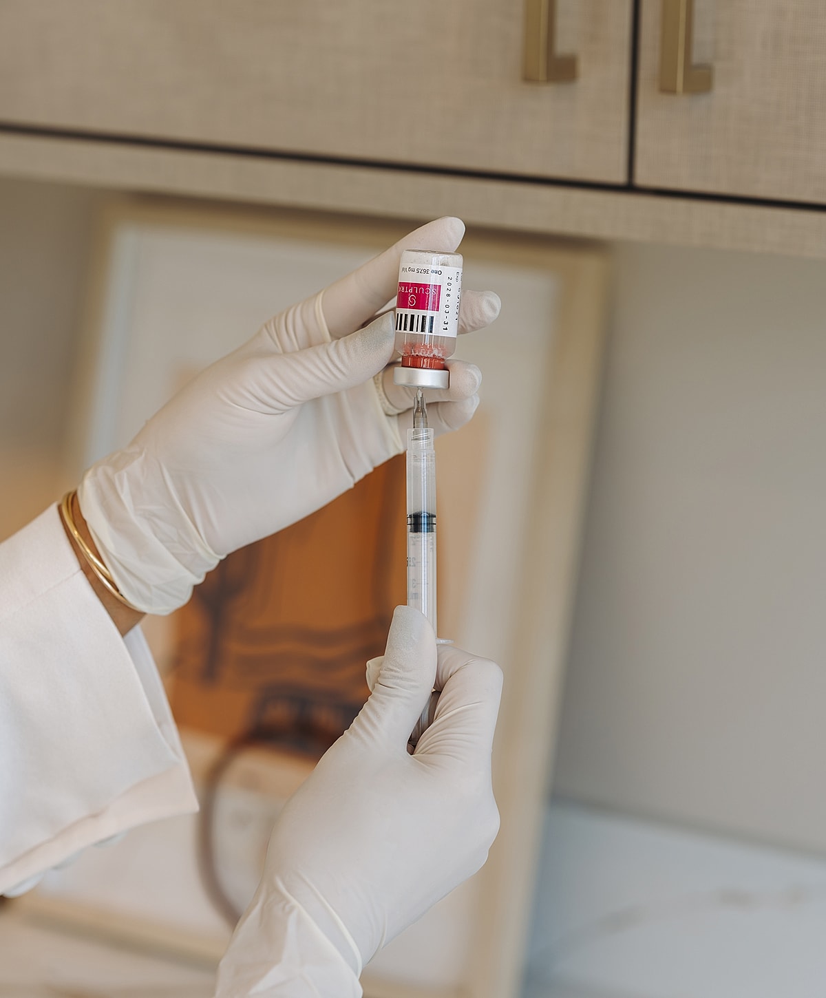 Preparing a vaccine dose with a syringe and vial.