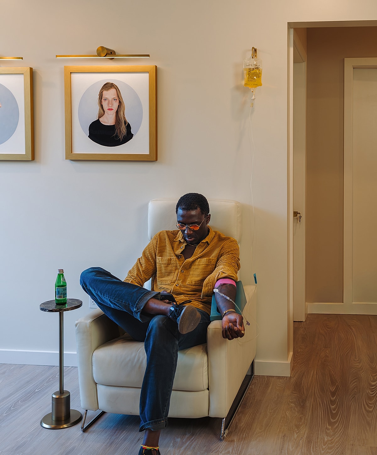 Man receiving IV treatment in a modern room.