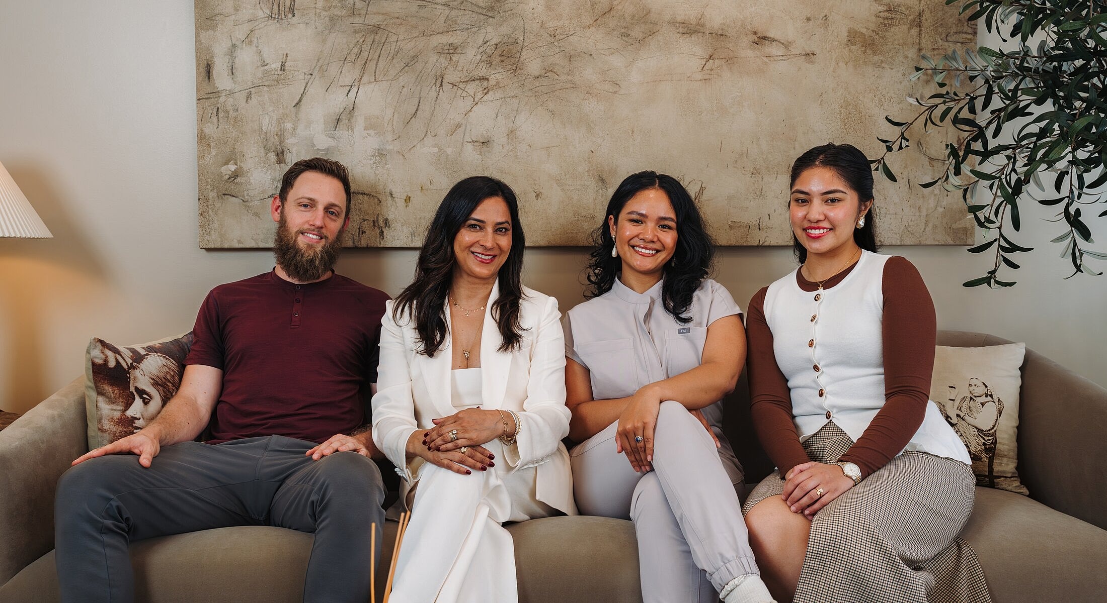 Group portrait of four people sitting together.