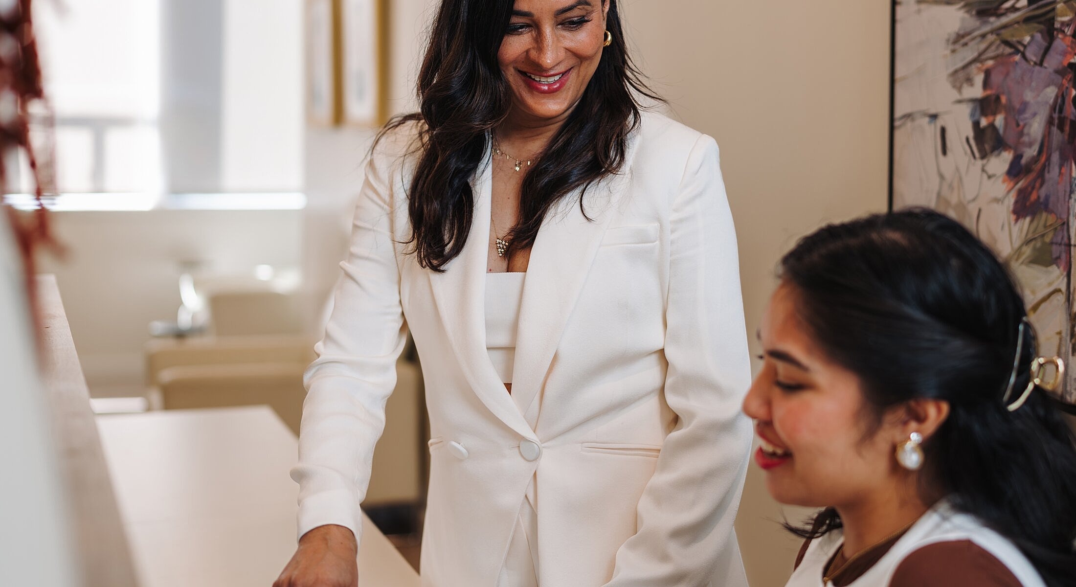 Businesswomen collaborating in a bright office.