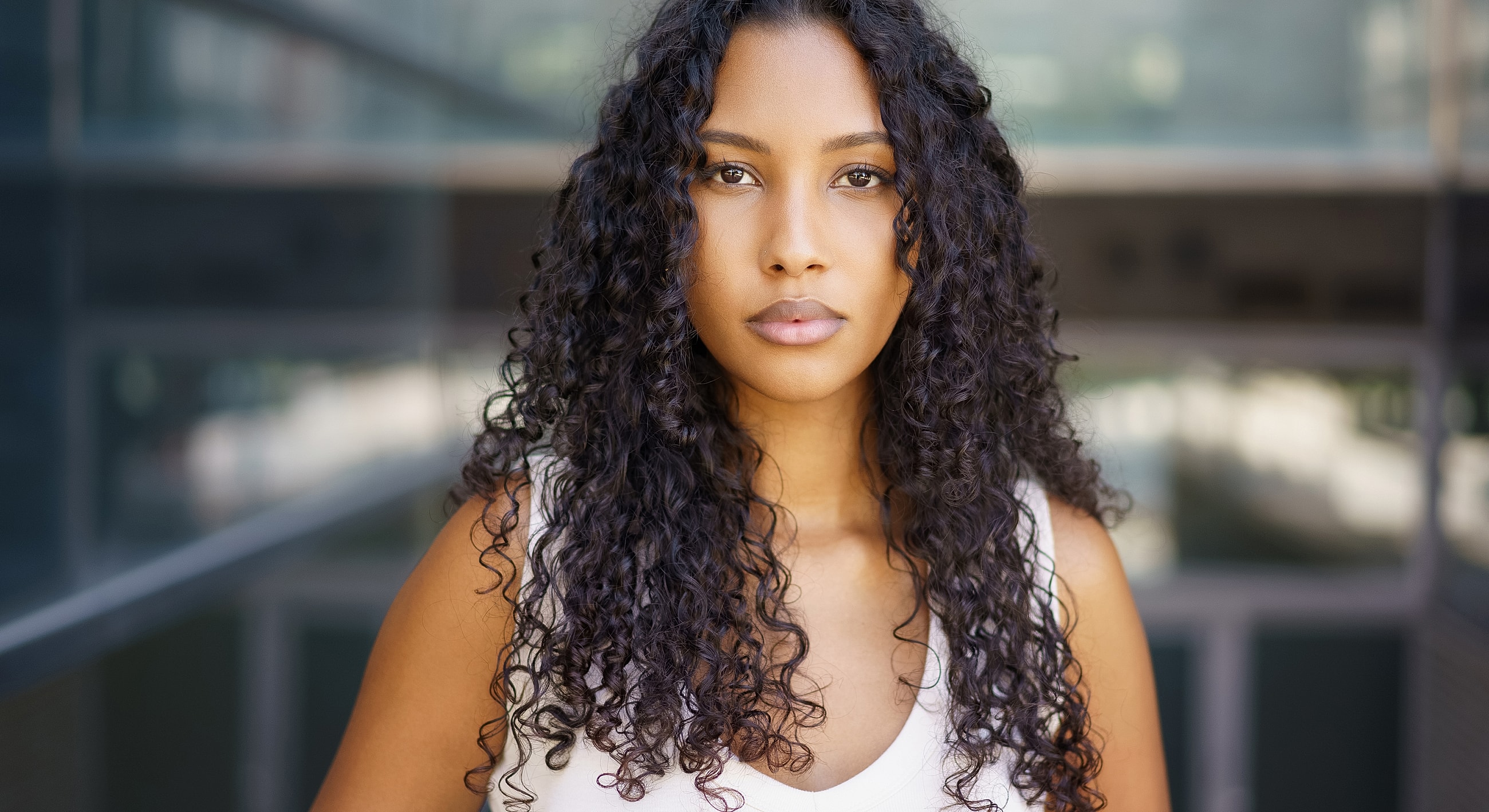 Woman with curly hair in a modern setting.